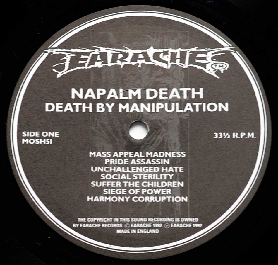 Close-up of the "Earache" Black and White Record Label for "NAPALM DEATH Death by Manipulation" 12" Side One