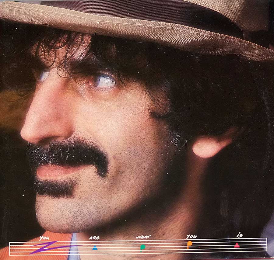 Large full page portrait photo of Frank Zappa on the front cover 