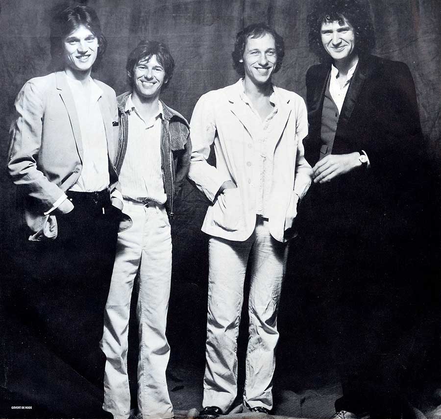 Large full-page group photo of the Dire Straits band 