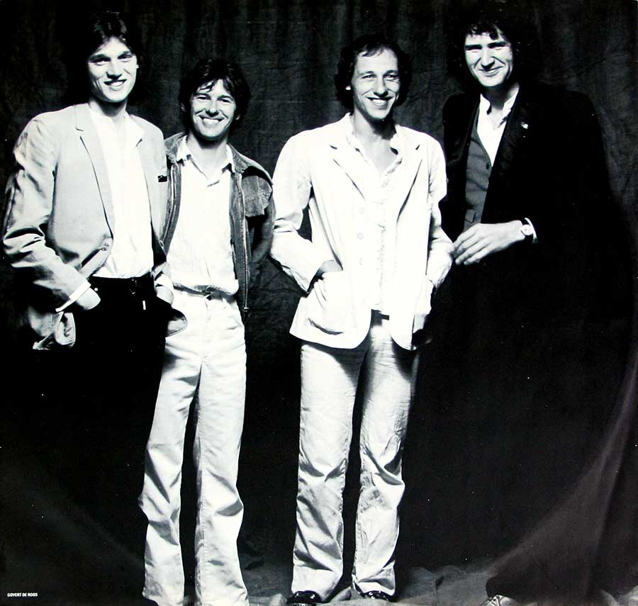 A full-page black and white group photo of the "Dire Straits" band