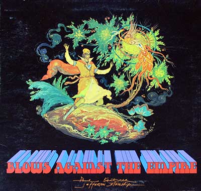 Album cover of Blows Against the Empire by Paul Kantner and Jefferson Starship. It features vibrant, psychedelic artwork with a mystical, almost surrealist style. The central figure is a man dressed in a flowing, otherworldly robe, standing on a small, planet-like surface. His arms are raised, reaching toward an elaborate, radiant object that resembles a sun or celestial being adorned with colorful feathers and surrounded by intricate patterns of plants and stars. The colors are bold, with vivid greens, blues, and yellows against a dark background, giving it an ethereal, cosmic quality. https://vinyl-records.nl