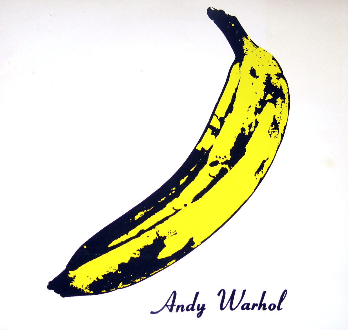 Iconic album cover of The Velvet Underground & Nico featuring a bright yellow banana with black spots and edges, set against a stark white background. The banana, created by Andy Warhol, has a slightly curved shape and a peeling suggestion near the tip. 'Andy Warhol' is written in a loose cursive font at the bottom right in dark purple. https://vinyl-records.nl