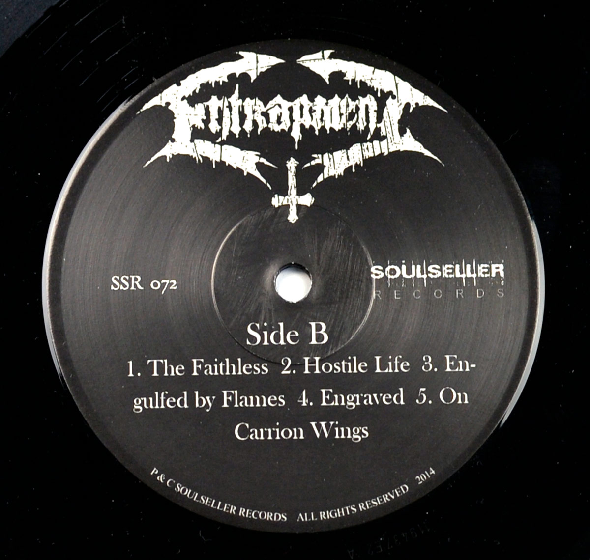 Label of Entrapment's 'Lamentations Of The Flesh' LP Side B with white text on black background, listing five tracks, Soulseller Records logo, and band logo above spindle hole.