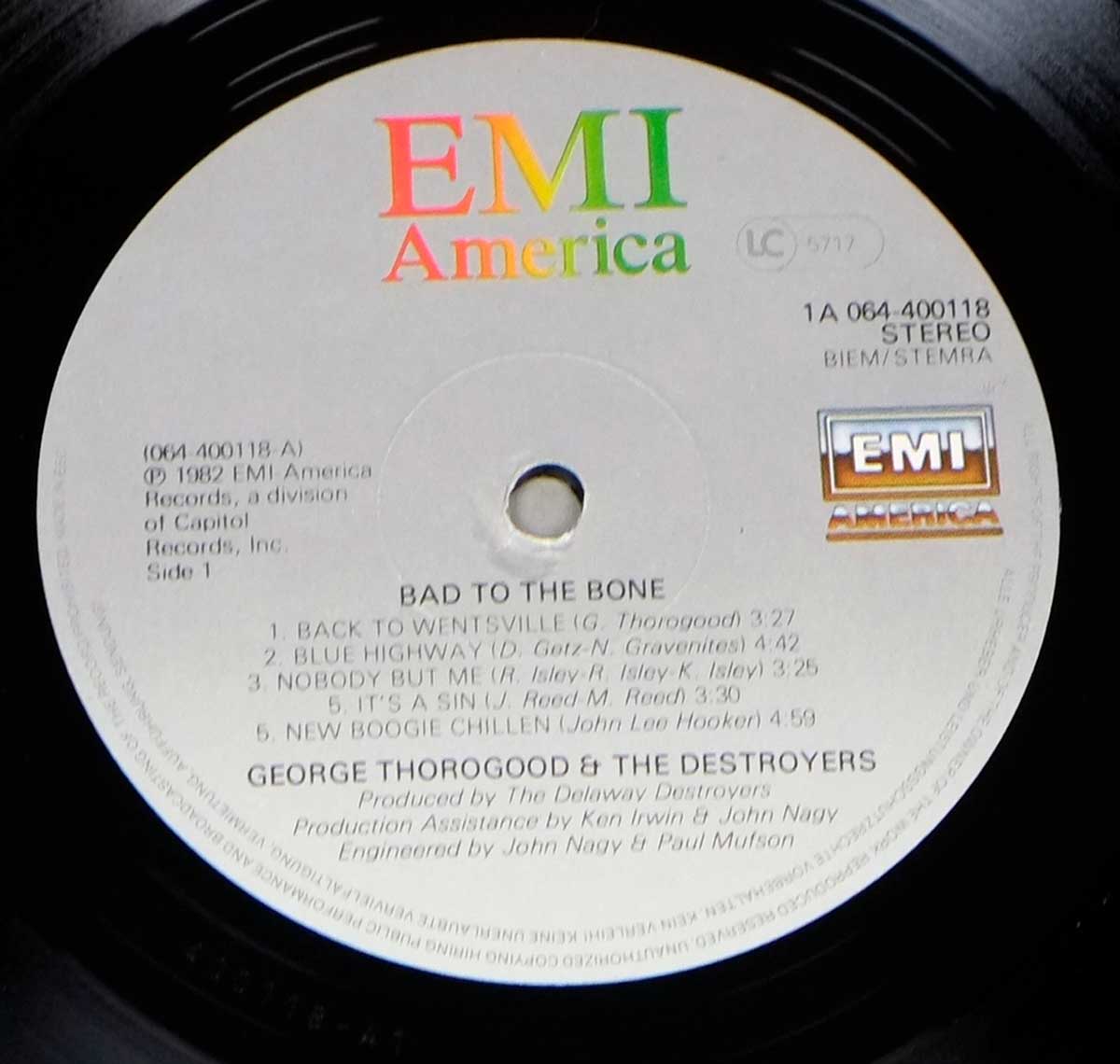 Side One label of George Thorogood & The Destroyers’ 1982 LP 'Bad to the Bone' on EMI America, showing track list, catalog number 1A 064-400118, and producer credits, with a centered spindle hole and colorful EMI America logo at the top.