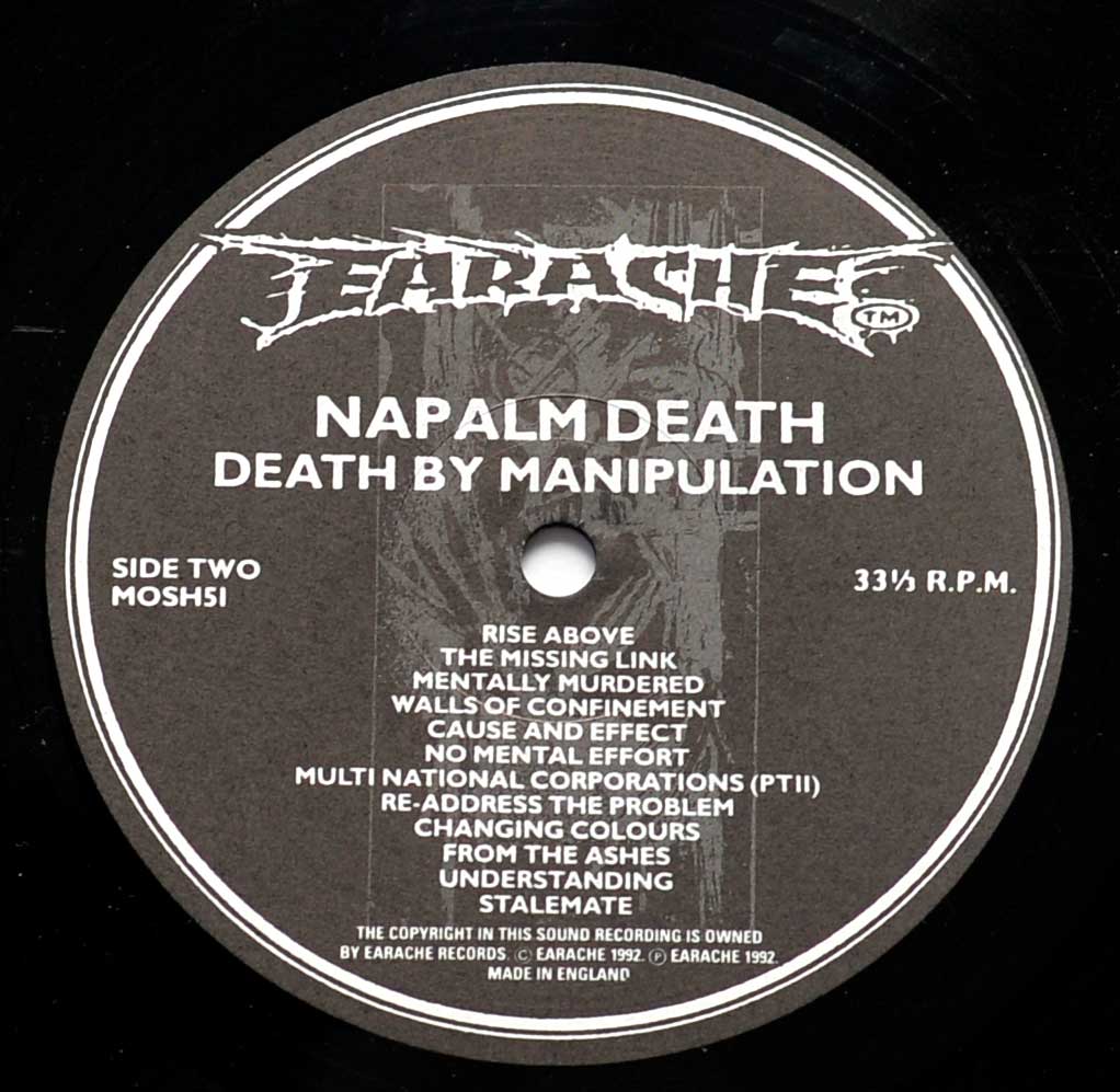 Close-up of the "Earache" Black and White Record Label for "NAPALM DEATH Death by Manipulation" Side Two