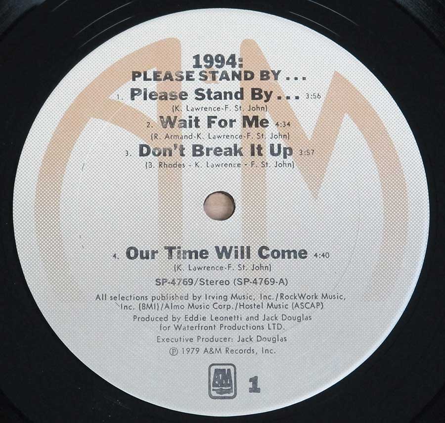 Close up of record's label 1994 ( Band ) - Please Stand By 12" Vinyl LP Album Side One