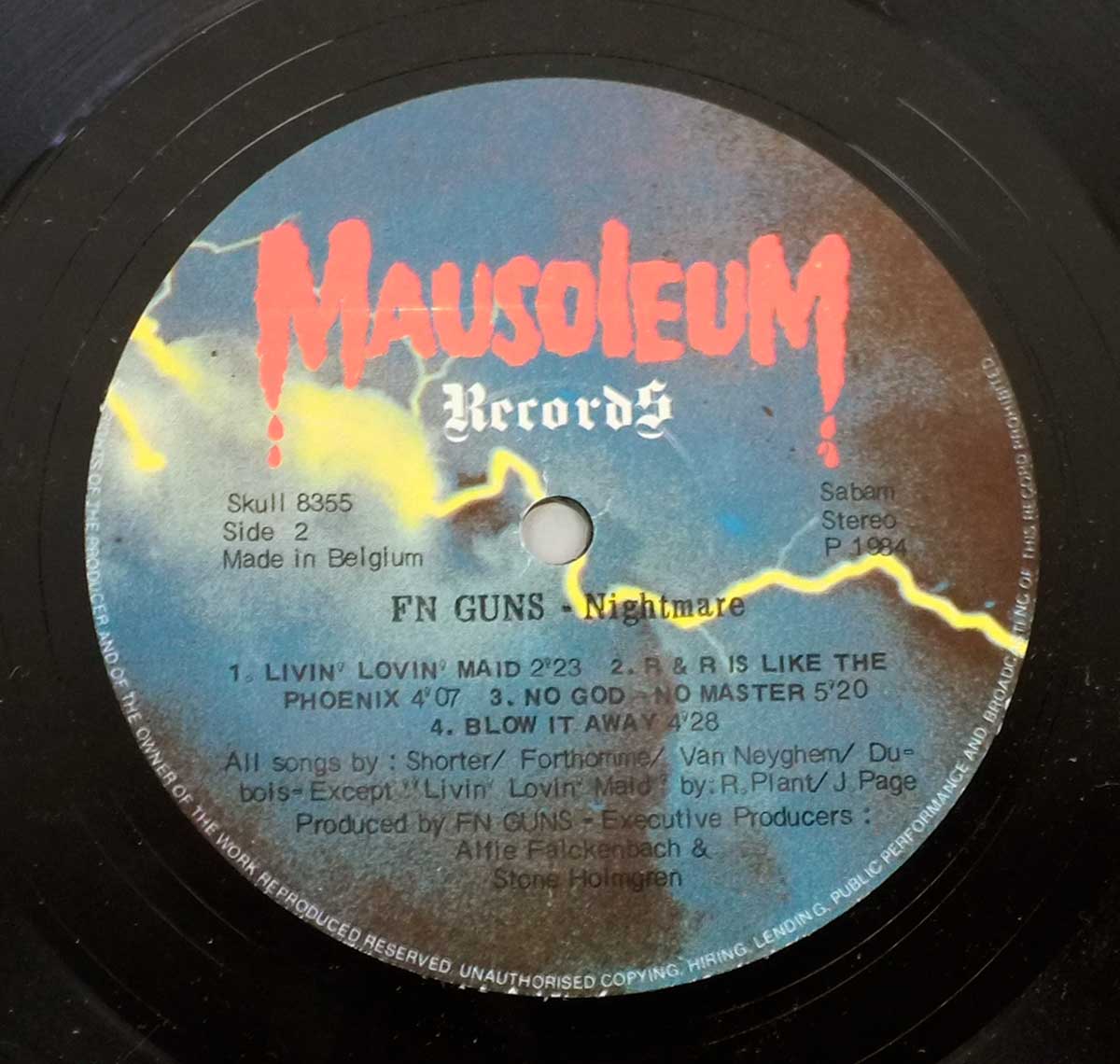 FN GUNS – Nightmare Side Two label with Mausoleum Records logo, track titles including Livin' Lovin' Maid and No God No Master, and production credits printed on a stormy blue and red background with yellow lightning bolt