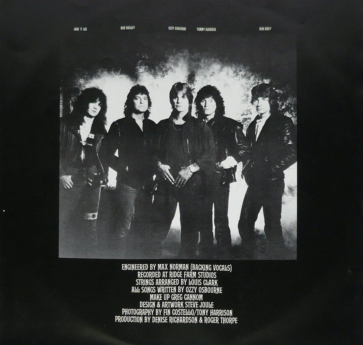 Black and white photo of Ozzy Osbourne and his band members standing confidently with smoke rising behind them; production credits printed below on a black background.