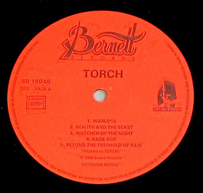 Close-up Photo of Red Bernett Record label for the album "TORCH - S/T Self-Titled" in France