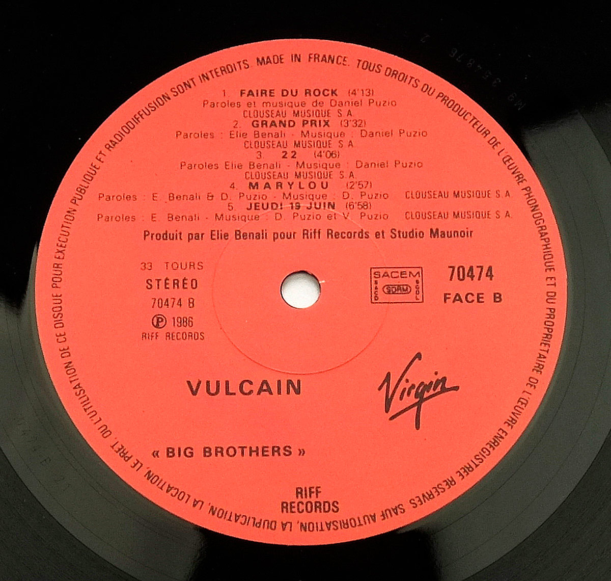 Close-up of Side B label on Vulcain's Big Brothers LP showing tracklist, catalog number 70474, Riff Records and Virgin logos, and production and rights info.