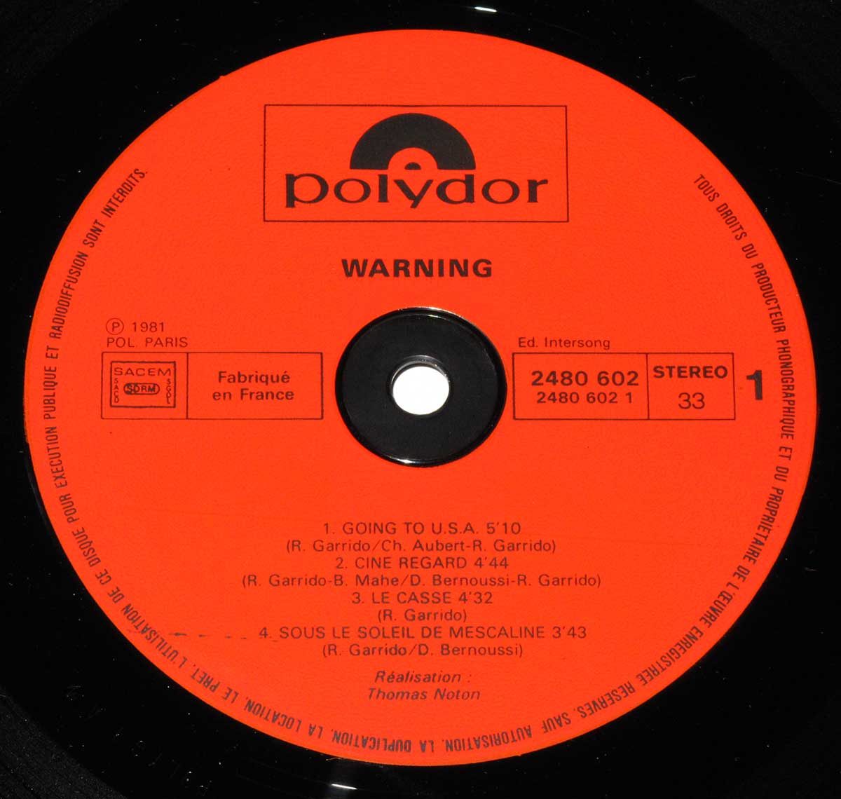 Close-up Photo of "WARNING - Self-Titled" Red Polydor Record Label  