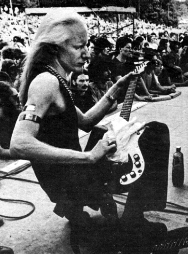 Photo of Johnny Winter Cleaning his Guitar Strings on Stage 