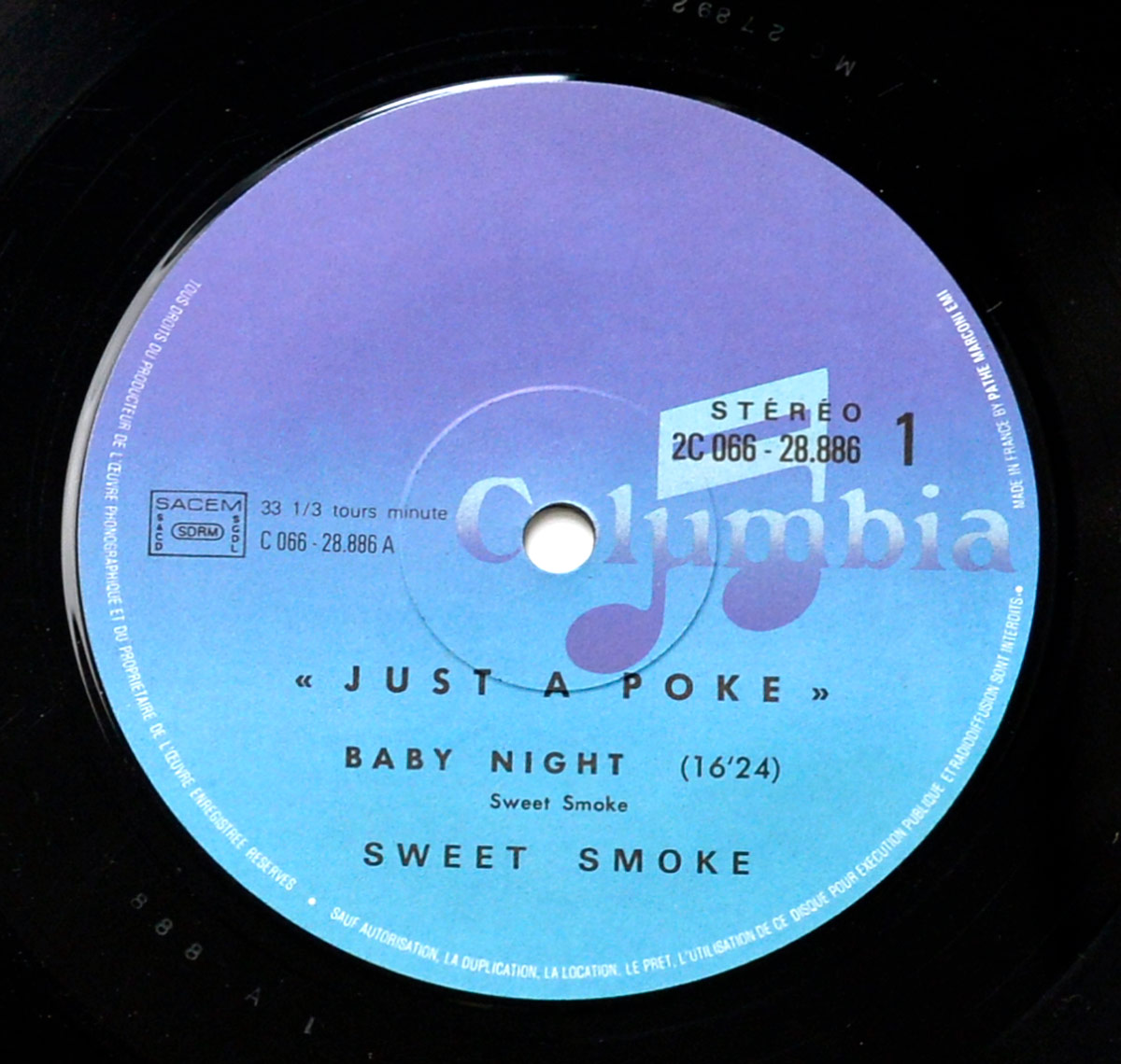 Close-up of Side One label of the French vinyl pressing SWEET SMOKE - Just a Poke, Columbia 2C 066-28.886, featuring track Baby Night, 33 1/3 RPM, purple-blue gradient background, SACEM rights, stereo indication, and Made in France note.