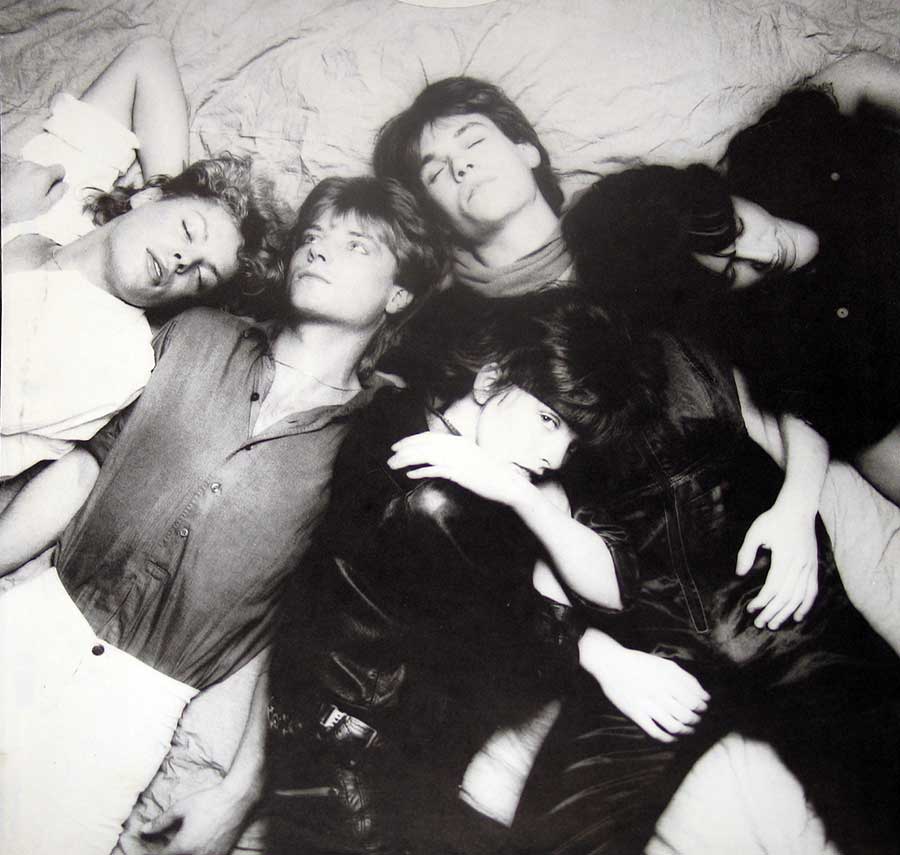 Group photo of the NENA band lying on the floor