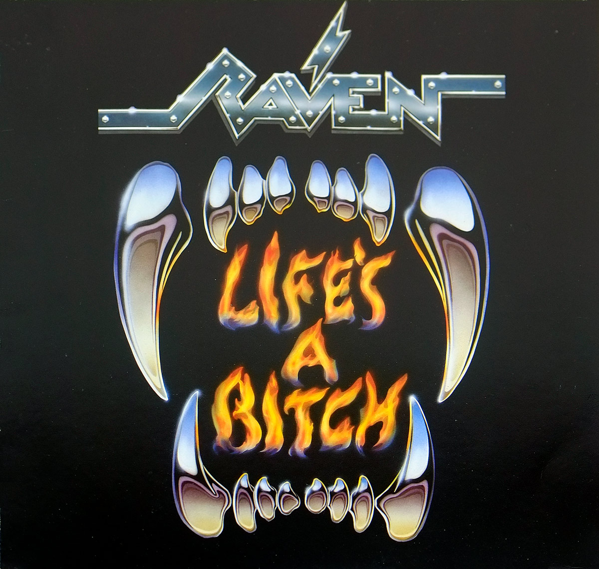 Album Front cover for Raven - Life's A Bitch, showing the metallic Raven logo at the top above a black background dominated by a huge open set of vampire-like fangs. The album title burns in orange and yellow flame-style lettering inside the mouth, giving the sleeve a blunt late-eighties metal-shop look: dark, loud, toothy, and about as subtle as a brick through a record shop window.