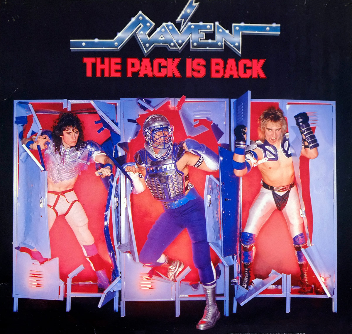 Album Front cover showing Raven's metallic blue-and-silver logo above the red title The Pack Is Back, with three band members bursting out of blue locker-like doors against a hot red background. The image is pure mid-80s metal theatre: sports armour, ripped panels, big hair, bright stage colours, and enough visual racket to make subtlety run for cover.
