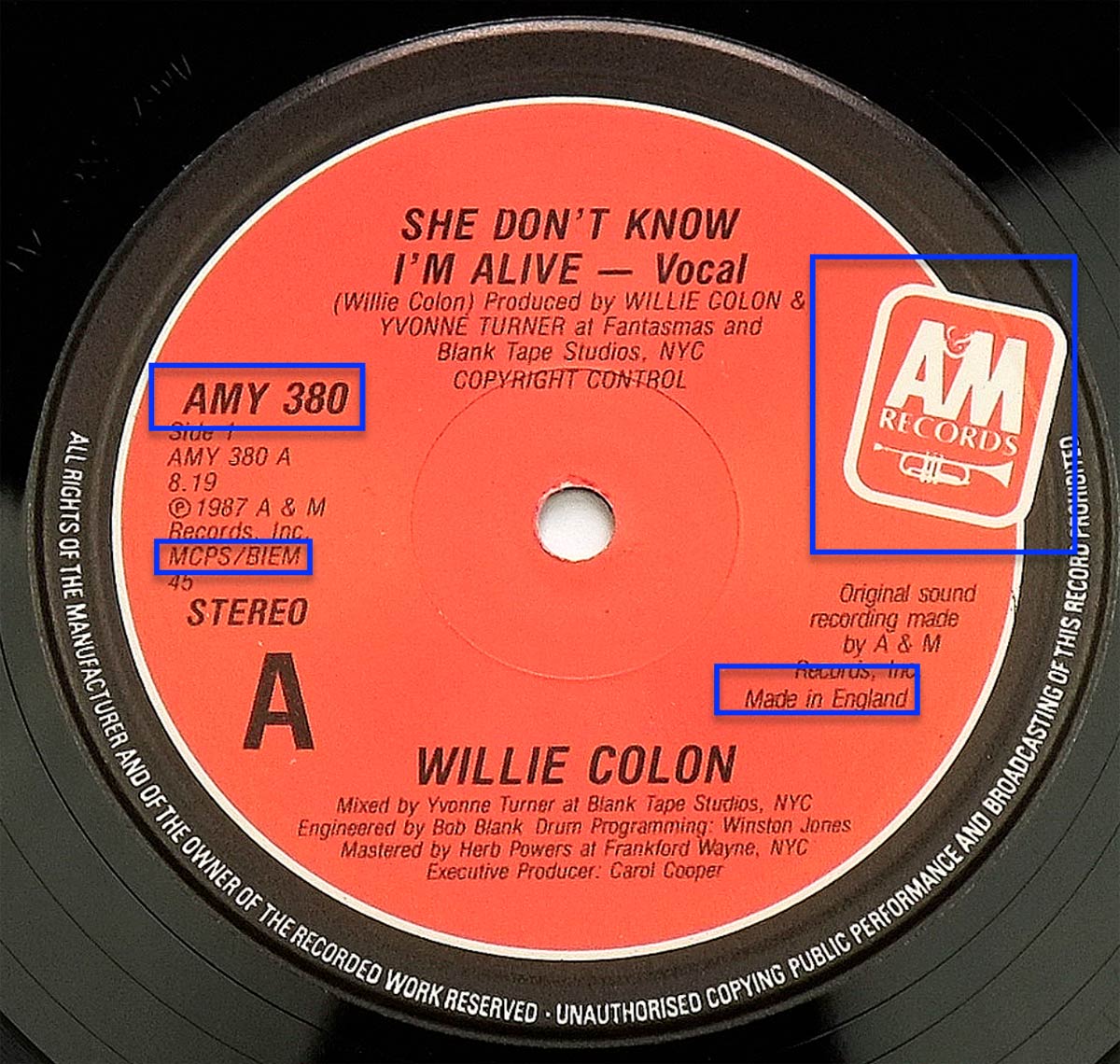 Side A label of the 1987 UK vinyl EP 'She Don't Know I'm Alive' by Willie Colón showing catalog number AMY 380, A&M Records logo, and Made in England marking.