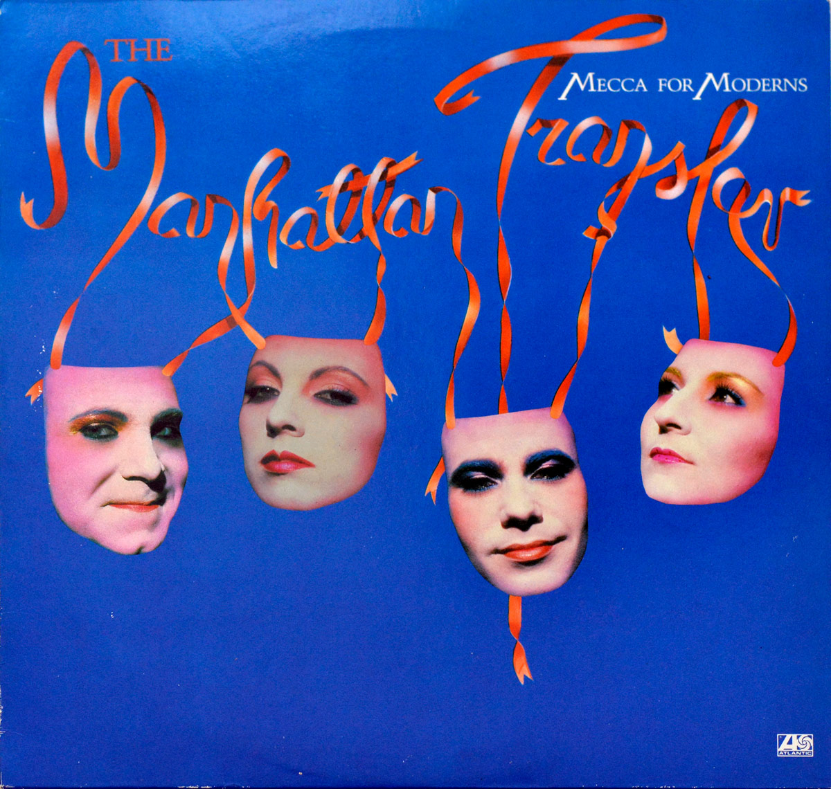 Front cover of THE MANHATTAN TRANSFER - Mecca For Moderns. Bright blue background with four pink theatrical masks floating, each featuring a band member's face. Orange ribbons connect the masks to the stylized ribbon-like text forming the band name. https://vinyl-records.nl