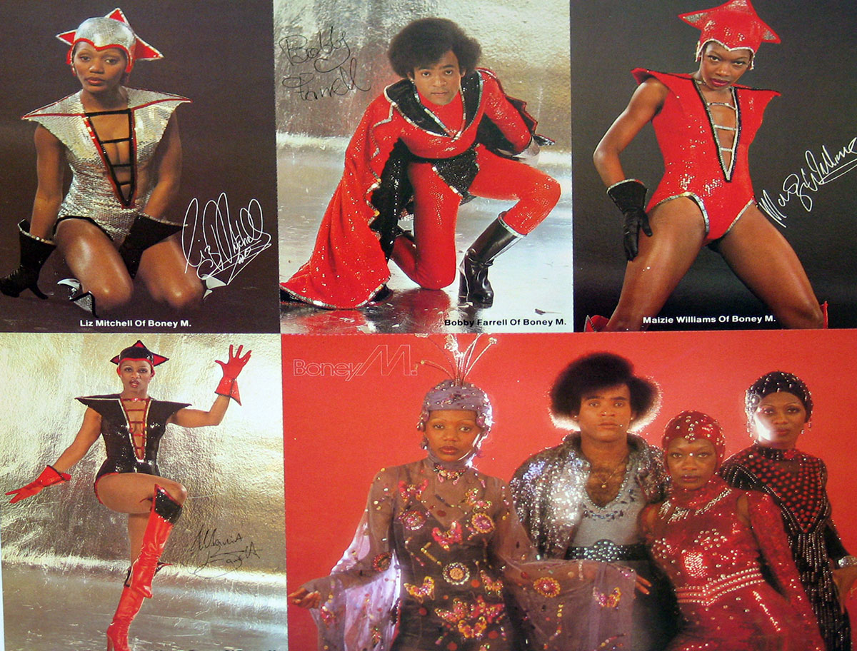 Postcard insert from Boney M's Nightflight to Venus featuring individual and group portraits of band members in theatrical red and silver disco costumes against metallic and red backdrops.