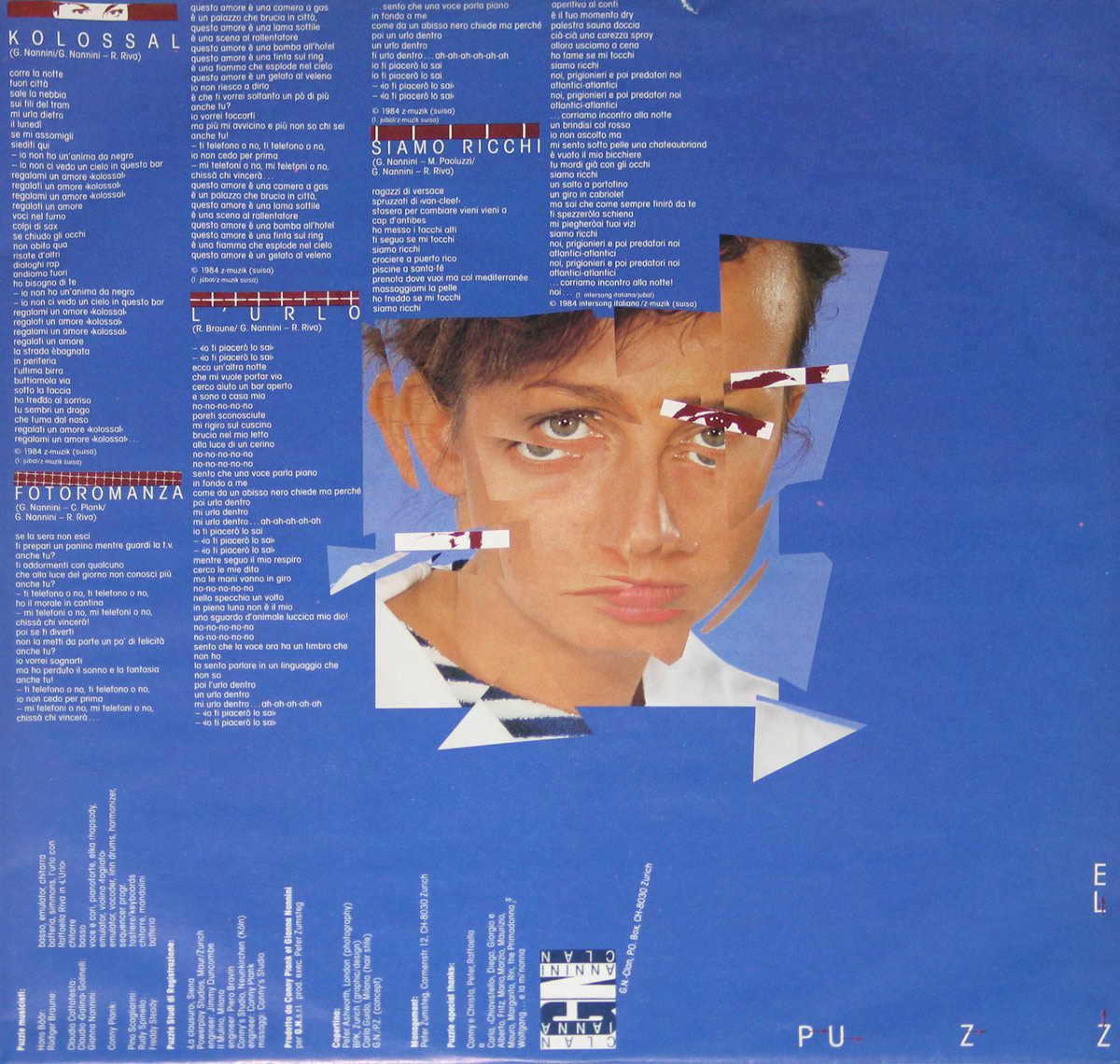 Back cover of the vinyl LP Puzzle featuring a deep blue background filled with dense white song lyrics and credits, a fragmented portrait of the artist’s eyes and face integrated into the layout, rotated typography, label logos, and precise late-1980s European sleeve design emphasizing text, structure, and print clarity.