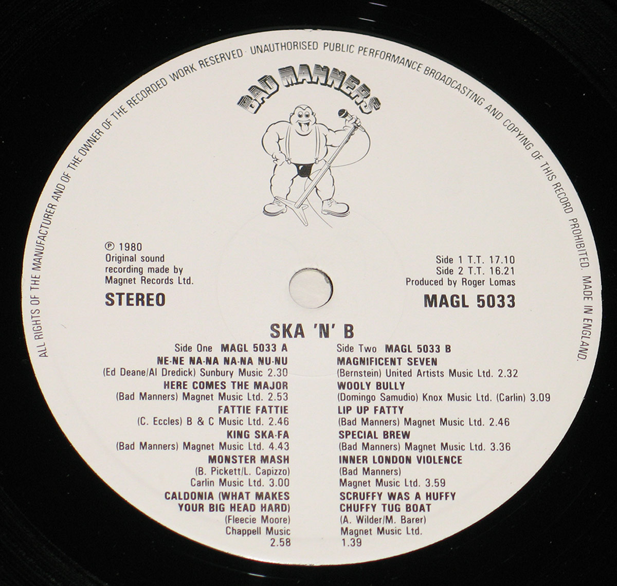 Record label of Bad Manners' Ska 'n' B LP (MAGL 5033), white background with black print showing band logo, track listings for both sides, songwriting credits, publishing info, and Magnet Records details. Features cartoon character logo of a muscular man with microphone at the top. Manufactured in England, stereo, produced by Roger Lomas.