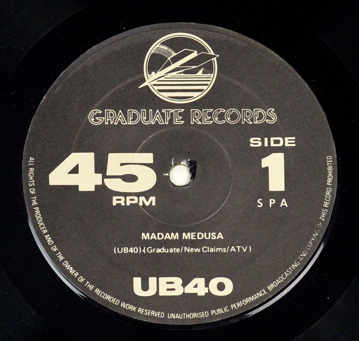 Close-up of UB40 Signing Off vinyl label Side 1, showing 45 RPM format, track title Madam Medusa, Graduate Records logo, publishing credits, and all rights reserved text.