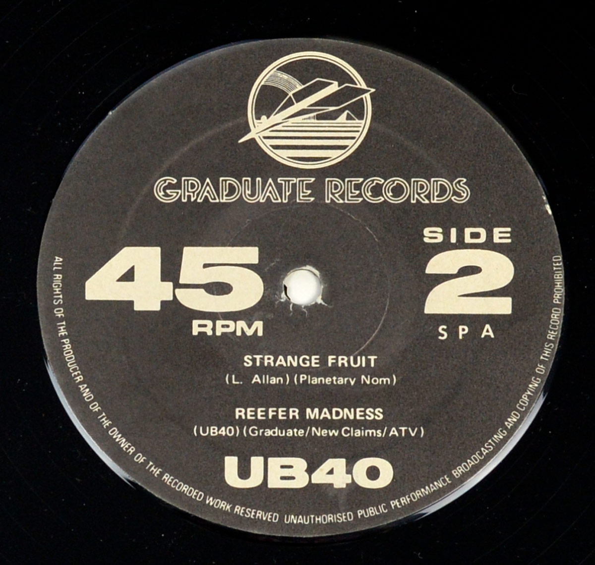 UB40 Signing Off vinyl label Side 2 with 45 RPM format, tracks Strange Fruit and Reefer Madness, Graduate Records logo, publishing credits, and copyright warning on a black background.