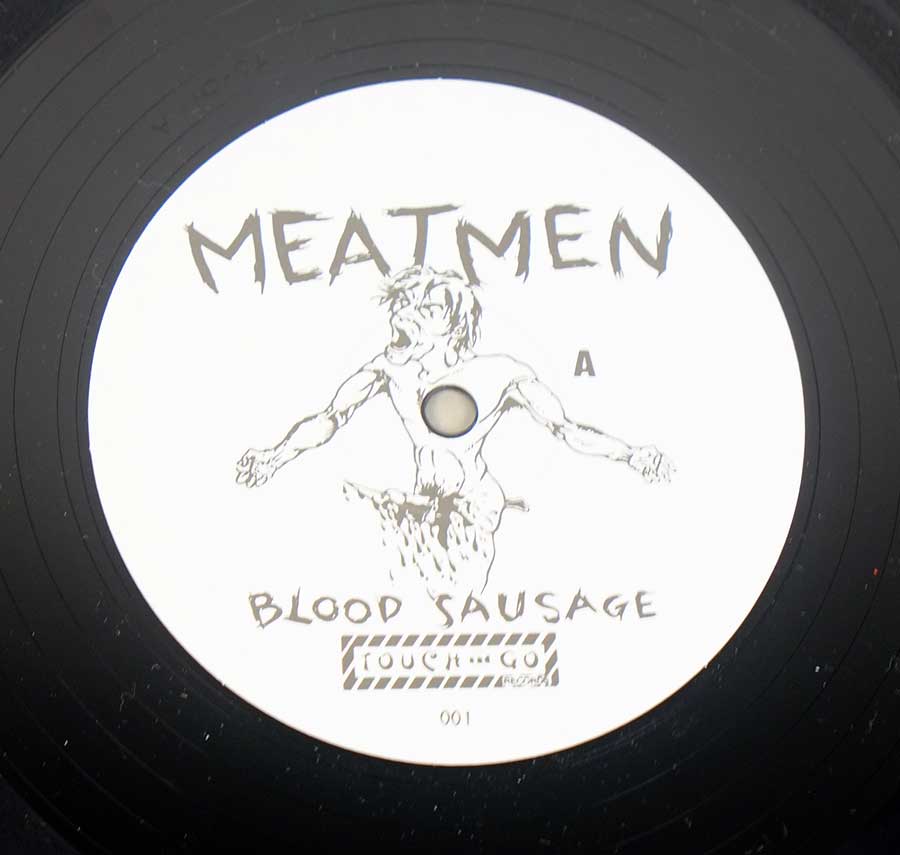 Close up of Side One record's label "We're The Meatmen And You Suck" Record Label Details: Touch and Go 001 