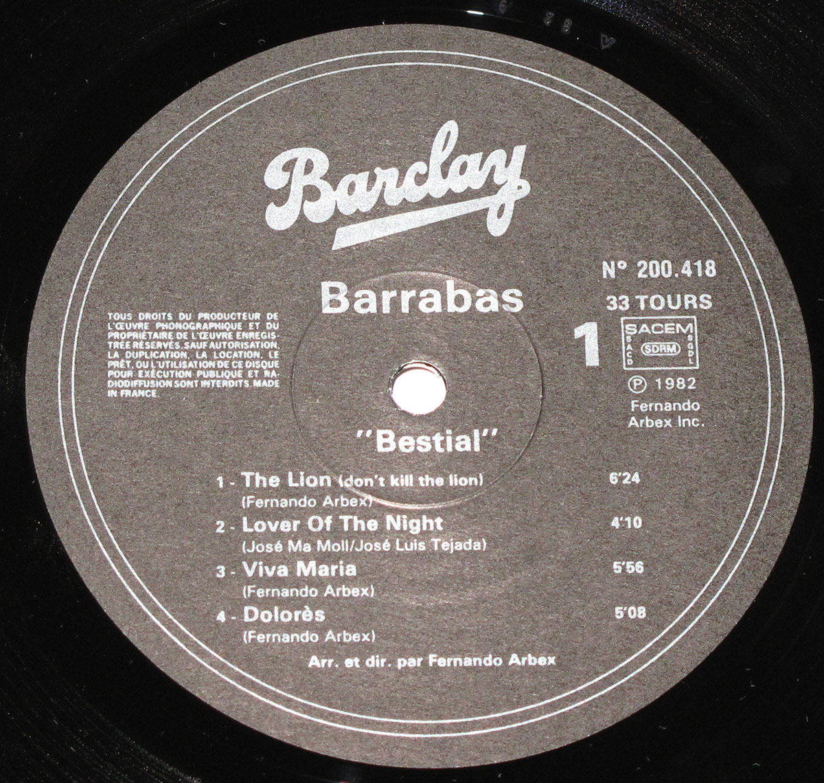 Close-up of Barrabas' 'Bestial' vinyl record label, featuring the Barclay logo, tracklist, and production details in white text on a black disc.