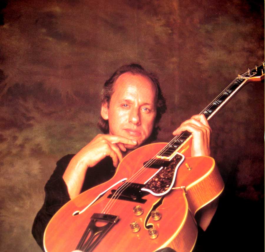 Large full-page photos of Mark Knopfler and his Gibson guitars 