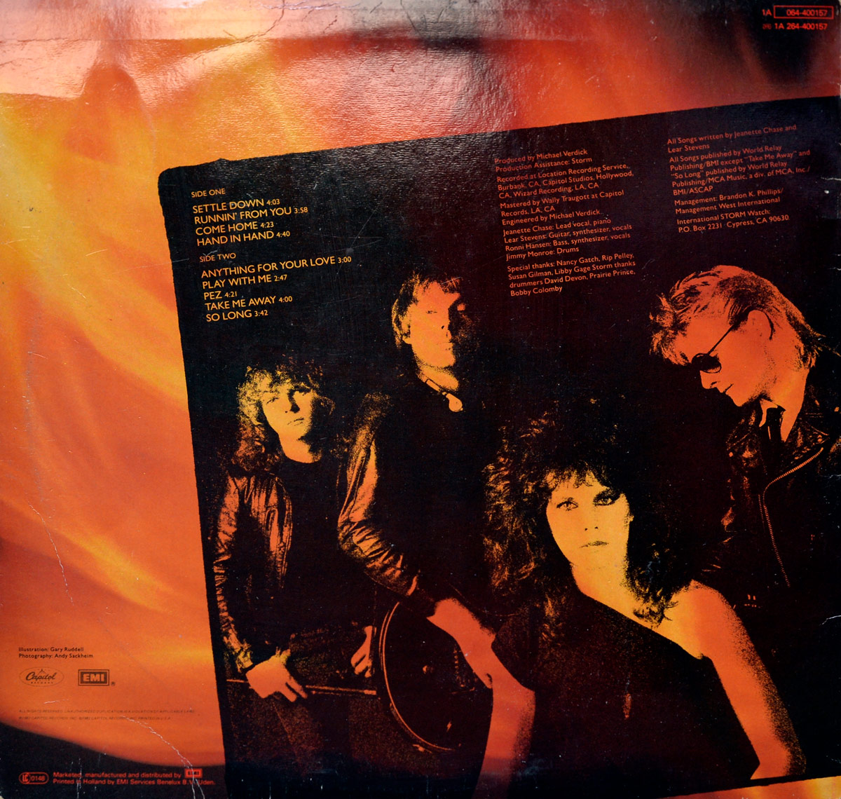 Back cover of STORM's self-titled album features an orange-red fiery gradient background, a band photo in monochrome red-yellow tones, full track list and production credits.