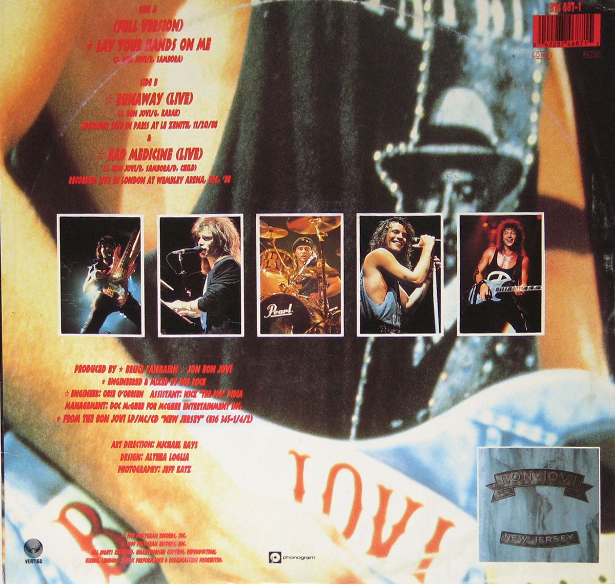 Back cover of Bon Jovi’s 1989 12-inch vinyl EP Lay Your Hands On Me. The design features a close-up of a guitar with the word BON JOVI painted across it, overlaid with bold red text listing the tracks: Side A Lay Your Hands On Me (Full Version), Side B Runaway (Live), and Bad Medicine (Live). Centered are five live performance photos of the band members: Richie Sambora on guitar, David Bryan on keyboards, Tico Torres on drums, Jon Bon Jovi singing, and Alec John Such on bass. Production credits appear in red text beneath, naming Bruce Fairbairn and Jon Bon Jovi as producers, with Bob Rock as engineer. Additional credits include Obi O’Brien, Nick Didia, Doc McGhee, Michael Bays, Althia Loglia, and Jeff Katz. At the bottom right, a small inset image of the Bon Jovi New Jersey album cover is displayed. A red barcode sits in the top right corner.