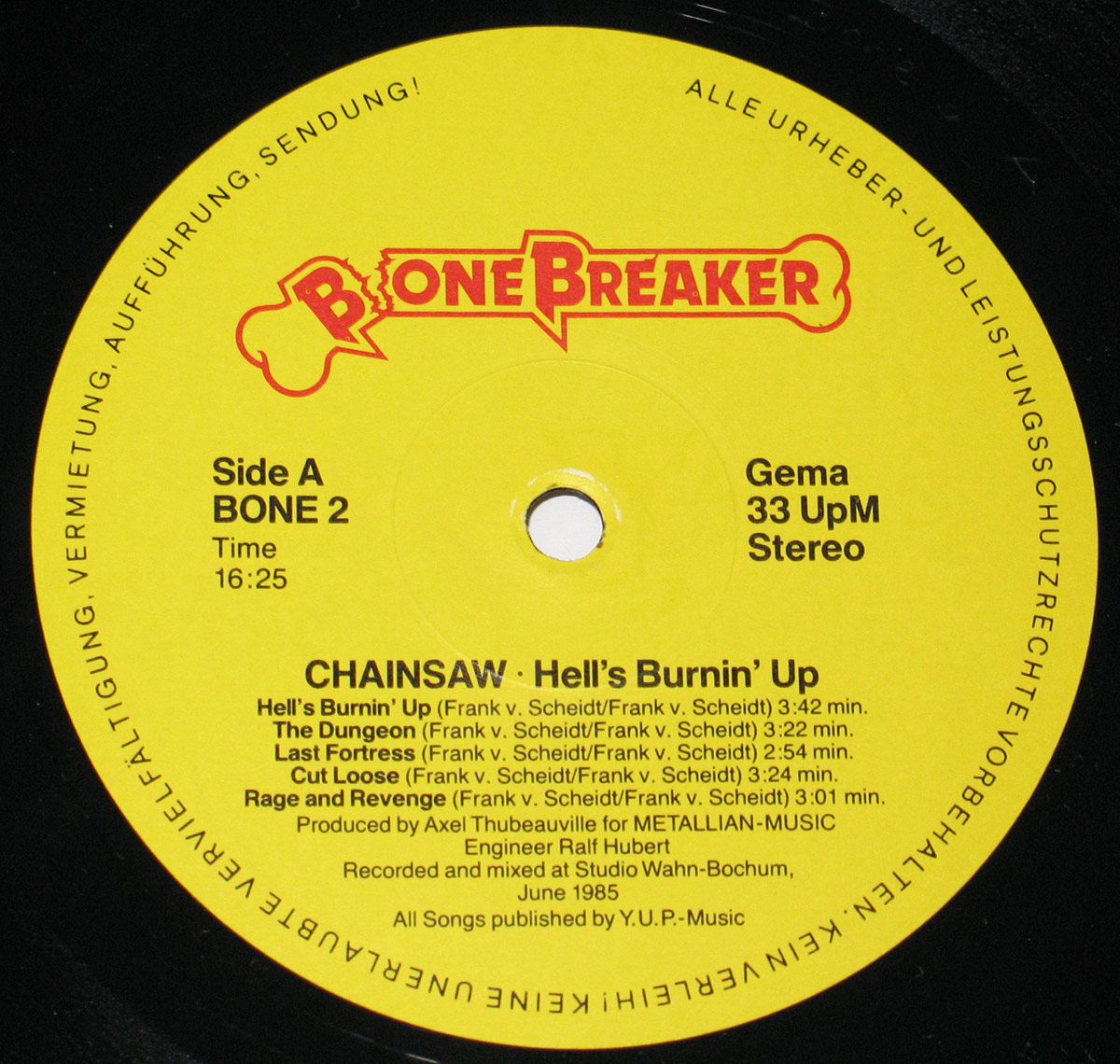 Yellow record label for Chainsaw’s album Hell’s Burnin’ Up! featuring the Bonebreaker logo in red with a breaking bone graphic, album details, production credits, and technical specifications like 33 RPM Stereo, with a copyright disclaimer around the edge https://vinyl-records.nl