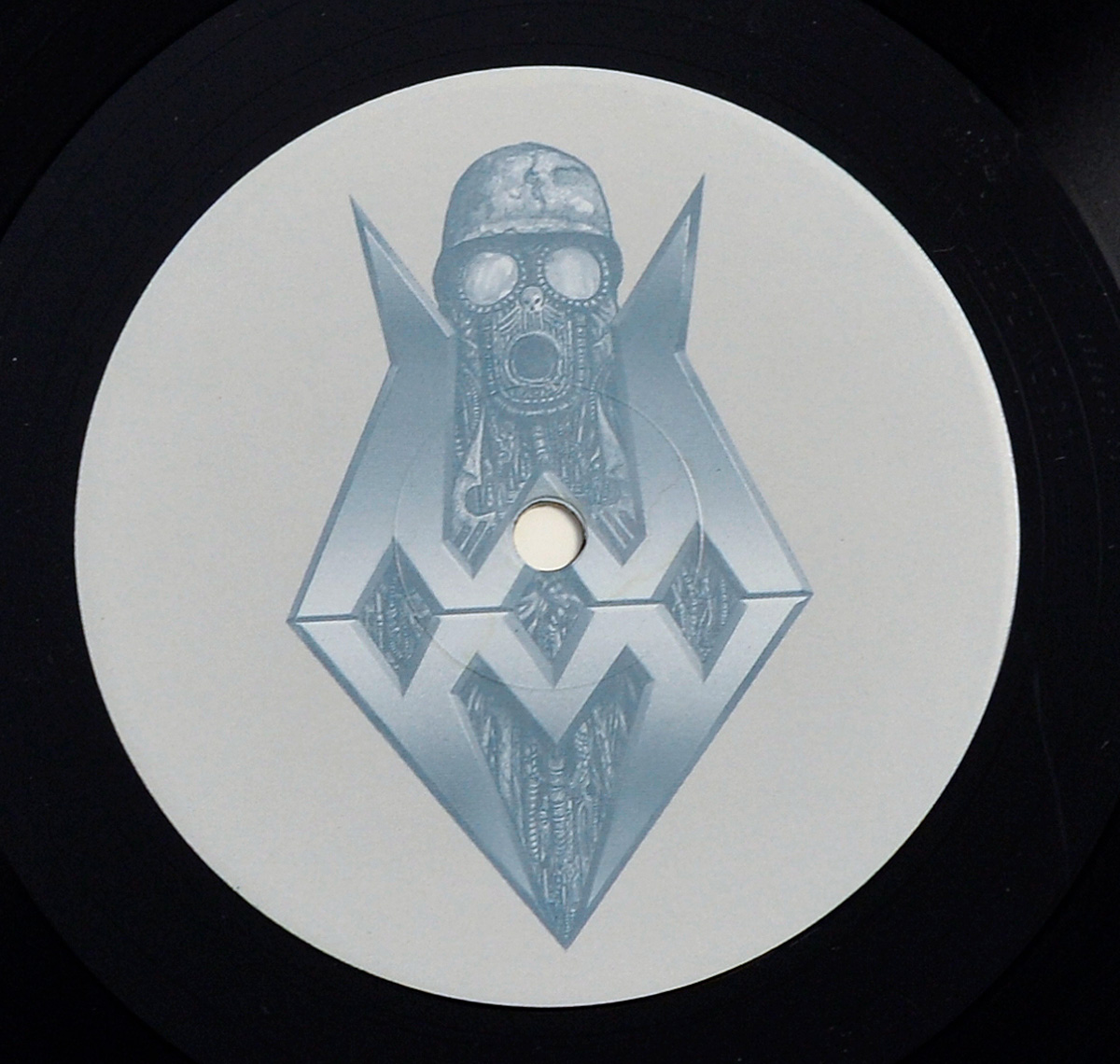 Side Two record label of Sodom’s Better Off Dead album, featuring a soldier with a gas mask and helmet inside a geometric diamond structure, rendered in a biomechanical style.